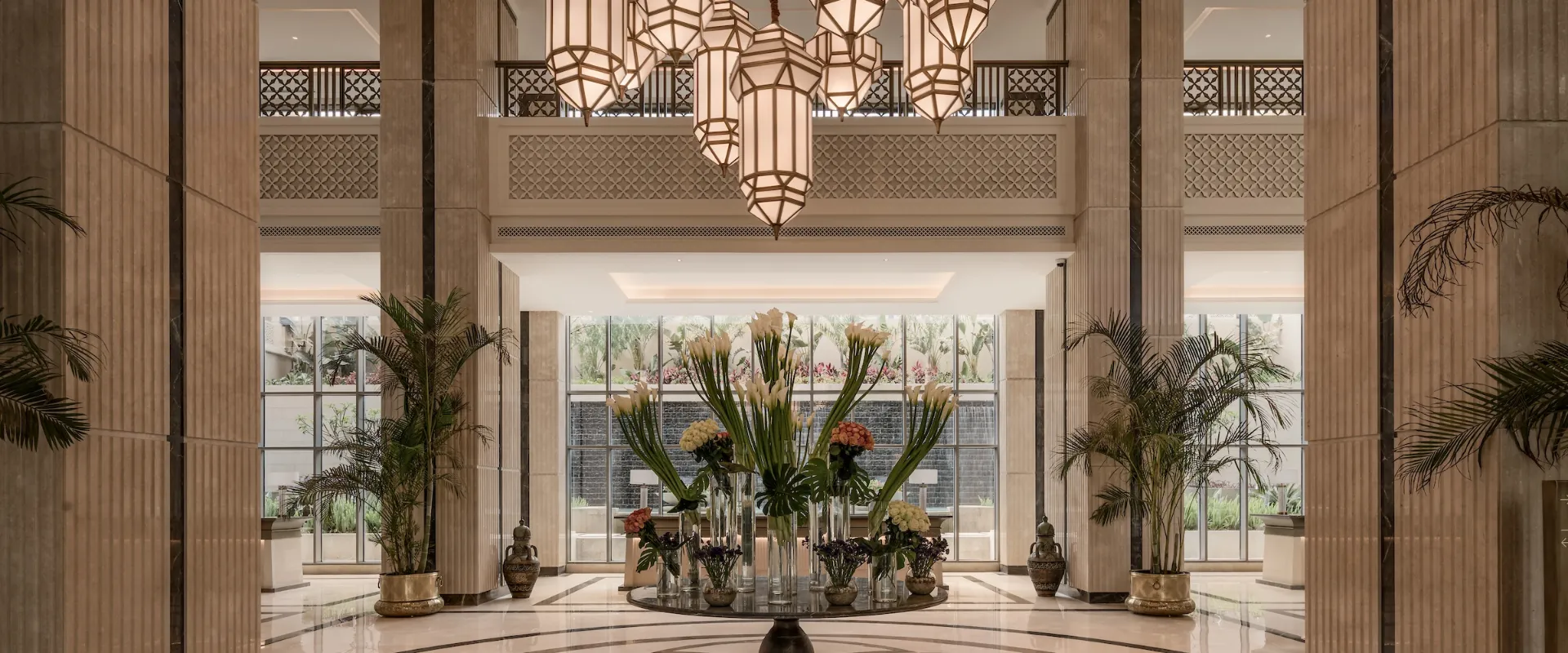 The grand lobby of Giza Palace Hotel & Spa — Egyptian-inspired lanterns, marble columns and a floral centrepiece.
